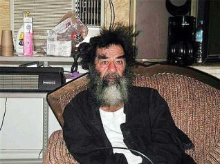 Deposed Iraqi President Saddam Hussein sits on a couch shortly after his capture by U.S. forces in a farm house outside Tikrit, Iraq, 14 December 2003. )Photo courtesy of www.military.com) dpa